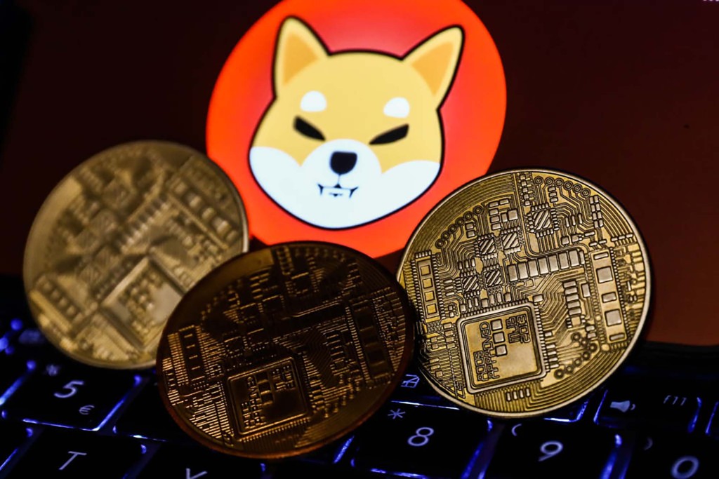 El dibujo del logotipo de Shiba Inu se muestra entre las criptomonedas de oro