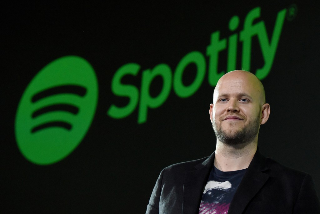 Daniel Ek de pie frente a una gran pantalla que muestra el logo de Spotify